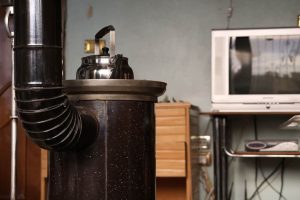 Older tank water heater in a home utility room